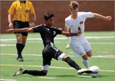  ?? Jeremy Stewart / Rome News-Tribune ?? Coosa’s Julian Perez (left) stretches out to keep the ball away from Benedictin­e’s Ross Monson during the first half of the Class AA boys’ state championsh­ip Saturday at Mercer University in Macon. The Eagles were defeated 4-1 by the Cadets.