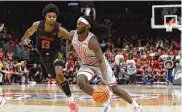  ?? JAY LAPRETE / AP ?? Ohio State’s Isaac Likekele (right) drives to the basket against Maryland on Senior Day, Wednesday, in Columbus. Likekele scored 11 points in OSU’s 73-62 win against No. 21 Maryland.