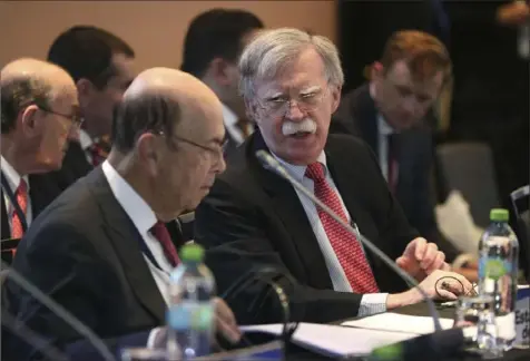  ?? Martin Mejia/Associated Press ?? National Security Adviser John Bolton, center, speaks with Commerce Secretary Wilbur Ross on Tuesday during a Lima, Peru-based conference of more than 50 nations that largely support Venezuelan opposition leader Juan Guaido.