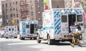  ?? Mary Altaffer / Associated Press ?? Ambulances line the street outside Elmhurst Hospital Center in the Queens borough of New York City. More than 3,500 people statewide have died from coronaviru­s infections.