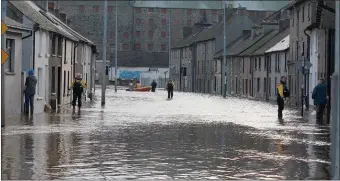  ??  ?? Slaney Search & Rescue members checking on residents of the Island Road during the flooding in 2015.