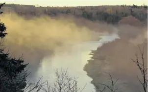  ??  ?? Bernice MacDonald watched as wispy morning fog rolled along the shores of the West River in Antigonish, N.S.