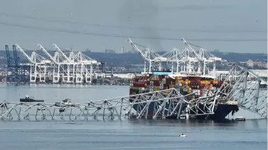  ?? (AP Photo/Steve Helber) ?? A cargo ship is stuck under the part of the structure of the Francis Scott Key Bridge after the ship hit the bridge Tuesday, March 26, 2024, in Baltimore, Md.