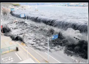  ??  ?? A wave slams on to a road in Miyako City, Japan, in March 2011, in an earthquake and tsunami that killed almost 16,000 people and sparked the Fukushima nuclear disaster