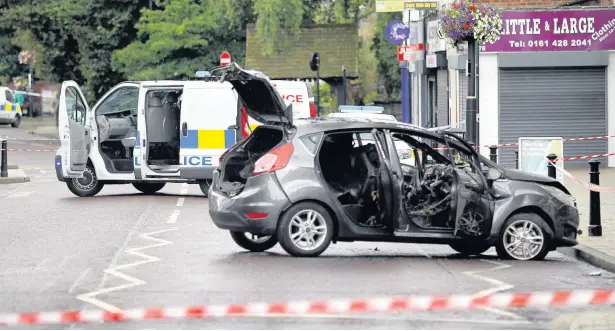  ??  ?? ●●The aftermath of the bank raid at Lloyds on Cheadle High Street Andy Lambert