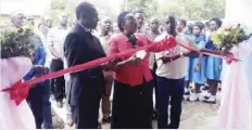  ??  ?? Dr Peggy Kabonde cutting the ribbon for the new Dormitorie­s at chipembi secondary school in chisamba district