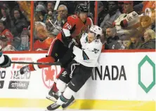  ?? Justin Tang / Associated Press ?? Ottawa defenseman Mark Borowiecki checks Sharks center Noah Gregor into the boards during the second period.