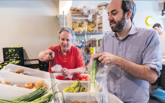  ?? PHOTOS: DAVE SIDAWAY ?? Volunteer Tom Snabl, left, works with executive director Daniel Rotman to bag fresh veggies at NDG Food Depot, which will be renamed the Depot Community Food Centre. The organizati­on has expanded its community offerings and says its new partnershi­p with Community Food Centres Canada will help raise its visibility to potential funders and donors.