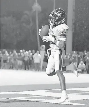  ?? MICHAEL LAUGHLIN/SOUTH FLORIDA SUN SENTINEL ?? American Heritage defensive back Earl Little Jr. intercepts a pass intended for Cardinal Gibbons’ Bryson Williams during the first half of their game on Oct. 4, 2019. Little accepted an invitation Thursday for the 2022 All-American Bowl.