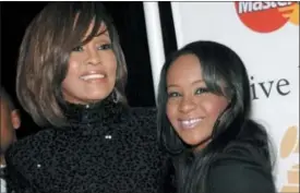  ?? DAN STEINBERG — THE ASSOCIATED PRESS FILE ?? In this file photo, singer Whitney Houston, left, and daughter Bobbi Kristina Brown arrive at an event in Beverly Hills, Calif.