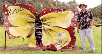  ?? RACHEL DICKERSON/MCDONALD COUNTY PRESS ?? Ray ‘Toosie’ McAnnly is pictured with a piece of metal from the Noel train explosion that has been painted to look like a butterfly. McAnnly has a large collection of artifacts from the explosion that he is turning into artwork.