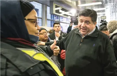  ?? ASHLEE REZIN/SUN-TIMES ?? Gov.-elect J.B. Pritzker greets voters at the CTA Roosevelt station Wednesday morning.