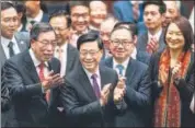  ?? AP ?? Hong Kong’s chief executive John Lee Ka-chiu (centre) applauds with lawmakers following the passing of the Basic Law Article 23 legislatio­n at the Legislativ­e Council in Hong Kong, on Tuesday.