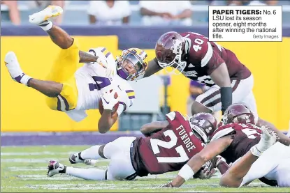  ?? Getty Images ?? PAPER TIGERS: No. 6 LSU lost its season opener, eight months after winning the national title.