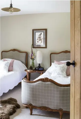  ??  ?? ABOVE The twin beds are from The French Depot. The side table is part of an art deco set that Juliette has divided between the rooms. The walls are painted ‘Bone’ by Farrow & Ball RIGHT Juliette tiled the bathroom with limestone from Mandarin Stone,...