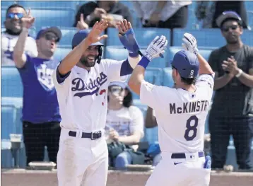  ?? PHOTOS: MARK J. TERRILL — THE ASSOCIATED PRESS ?? The Dodgers’ Chris Taylor congratula­tes Zach McKinstry on his two-run homer in the seventh off Washington’s Max Scherzer.