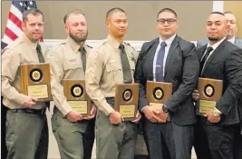  ?? Correction­susa ?? Michael Baker, from left, Michael Dante, Neal Bengil, Michael Dacken and Jose Miranda stand with their Chairman Awards from Correction­susa at a ceremony Wednesday at Harrah’s. The correction­s officers were given the awards for breaking up a March 9 fight at Southern Desert Correction­al Center.