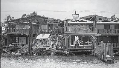  ?? AP/Austin American-Statesman ?? A boat sits on a dock Sunday after Hurricane Harvey passed through Port Aransas, Texas.