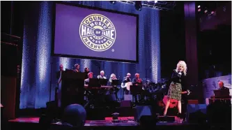  ??  ?? Far right, artist Dolly Parton sings to artist and Country Music Hall of Fame inductee Fred Foster, bottom left, at the Country Music Hall of Fame Medallion Ceremony.