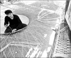  ??  ?? Afghani fishermen weave cages used for fishing in the United Arab Emirates in eastern coastal town of Kalba. Kalba has become a hub for the craft of weaving fishing cages, attracting dozens of Afghans and Pakistanis seeking to earn a living in the calm...