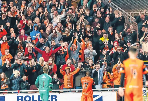  ??  ?? Wato Kuate (No 17) celebrates his goal with the fans during Dundee United’s 3-0 play-off quarter-final win against Morton at Tannadice.
