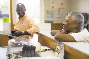  ??  ?? Loren Taylor gets a smile from his mom, Linda Taylor, before they head out to talk with potential voters in Oakland’s Ridgemont neighborho­od.