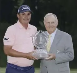  ??  ?? DUBLIN: Jack Nicklaus, right, hands Jason Dufner the trophy after Dufner won the Memorial golf tournament, Sunday, in Dublin, Ohio. — AP