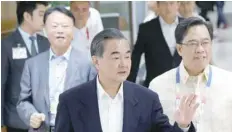  ?? — Reuters ?? Chinese Foreign Minister Wang Yi before boarding a plane during his departure at the internatio­nal airport in Pasay city, metro Manila, on Tuesday.