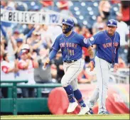  ?? Nick Wass / Associated Press ?? Mets outfielder Kevin Pillar reacts after he hit a grand slam and rounded third past third base coach Gary Disarcina, right, during the ninth inning against the Nationals on Sunday in Washington.