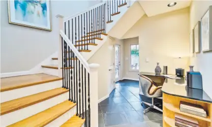  ?? VICTOR LIN PHOTOGRAPH­Y ?? A turned staircase beside an office nook ascends to the upper level of the Palo Alto home.