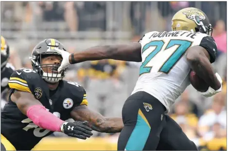  ?? Peter Diana/Post-Gazette ?? Jacksonvil­le’s Leonard Fournette breaks away from Bud Dupree — part of his 181-yard day a week ago at Heinz Field.