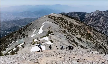  ?? Photograph: trekandsho­ot/Alamy ?? Hikers descending the Devils Backbone trail on Mount Baldy in the San Gabriel Mountains near Los Angeles, in May 2022.