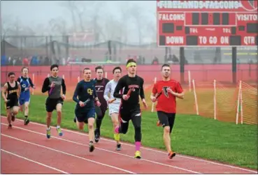  ?? ERIC BONZAR — THE MORNING JOURNAL ?? Runners compete in a relay during the Nelson Howe Invitation­al at Firelands High School on March 31.
