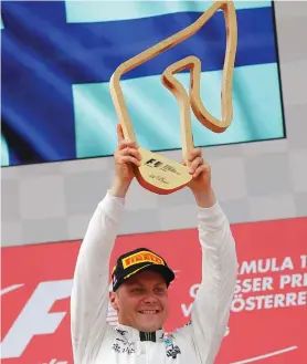  ??  ?? RING RESULT: Mercedes’ Valtteri Bottas celebrates his win on the podium.