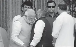  ?? DEEPAK GUPTA/ HT ?? Prime Minister Narendra Modi interacts with former SP chief Mulayam Singh Yadav during the oath ceremony of Yogi Adityanath in Lucknow on Sunday.