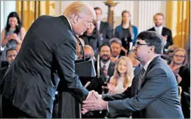  ?? MARK WILSON/GETTY ?? President Trump surprises Robert Wilkie with the Veterans Affairs nomination announceme­nt during a prison policies event Friday in the East Room of the White House.