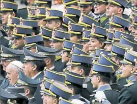  ?? Gregorio Borgia/Associated Press ?? Pope Francis poses for a picture with Italian Finance Police cadets and officers during the weekly general audience Wednesday at the Vatican.