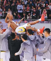  ?? ZHANG CHENLIN / XINHUA ?? Marbury is hoisted by teammates after Sunday’s 104-92 victory over Jiangsu Dragons Kentier. His final CBA appearance closed the curtain on a 22-year profession­al career.