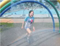  ?? DAVE STEWART/THE GUARDIAN ?? Anna Garrity, 11, tries to beat the heat by cooling off under one of the sprinkler systems at Victoria Park in Charlottet­own on a day this past week where temperatur­es climbed past 30 C.