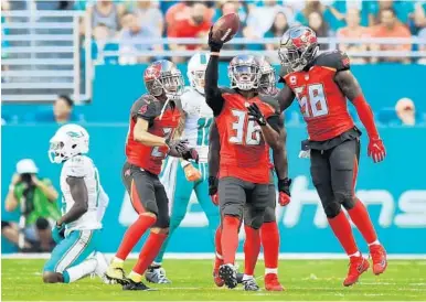  ?? JIM RASSOL/STAFF PHOTOGRAPH­ER ?? Tampa Bay Buccaneers defensive back Robert McClain (36) recovers a fumble in the second quarter of Sunday’s game.