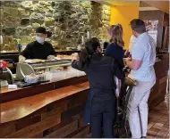  ?? COURTESY PHOTO ?? On Easter Sunday, a family watches a chef prepare sushi at Lily Asian Cuisine Sushi & Grill at 104 W. State St. in downtown Kennett Square.