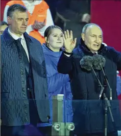  ?? ALEXANDER ZEMLIANICH­ENKO/AP ?? Russian President Vladimir Putin waves to the crowd Monday on Red Square in Moscow at a celebratio­n of his victory in the presidenti­al election and of the 10-year anniversar­y of the annexation of Crimea, which Russia seized from Ukraine in a move widely denounced as illegal.