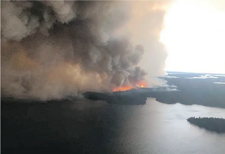  ?? PHOTOS: JUDY KLASSEN VIA THE CANADIAN PRESS ?? Manitoba MLA Judy Klassen provided this image showing a large forest fire seen burning near Wasagamack First Nation in northern Manitoba on Tuesday.