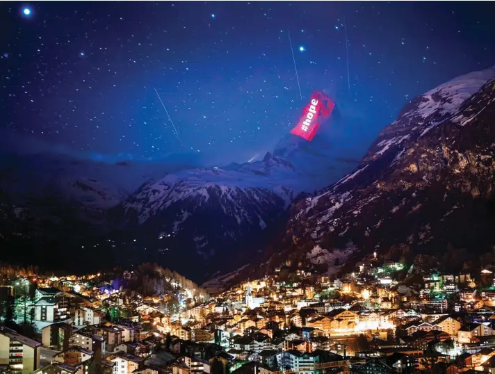  ??  ?? The iconic Matterhorn mountain is illuminate­d by Swiss light artist Gerry Hofstetter aiming to send messages of hope, support and solidarity to the ones sufferings from the Coronaviru­s pandemic, COVID-19, pandemic in the alpine resort of Zermatt, Switzerlan­d, on Thursday. The new coronaviru­s causes mild or moderate symptoms for most people, but for some, especially older adults and people who have underlying health conditions, it can cause more severe illness or death. Photo: AP