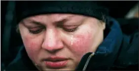  ?? ?? Tamara cries Feb. 22 next to the body of her husband Roman Shevchenko during his funeral in Bila Tserkva.