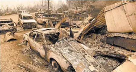  ?? JOSH EDELSON/GETTY-AFP ?? Burned vehicles smolder Tuesday at a residence in the Creek fire in an unincorpor­ated area of Fresno County, California.