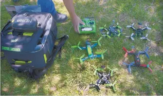  ?? GREG SORBER/JOURNAL ?? James Perez picks up the radio controller he uses to pilot his quadcopter­s. The propeller-driven craft are about the size of a dinner plate and weigh less than 10 ounces.