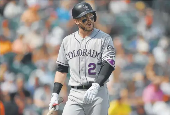  ?? Thearon W. Henderson, Getty Images ?? Rockies shortstop Trevor Story walks back to the dugout after being called out on strikes during the sixth inning Wednesday.