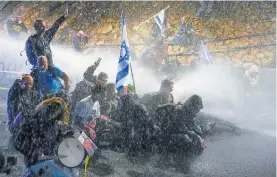  ?? Photo / AP ?? Police in Tel Aviv use water cannon to disperse demonstrat­ors in Israel opposed to Benjamin Netanyahu’s leadership.