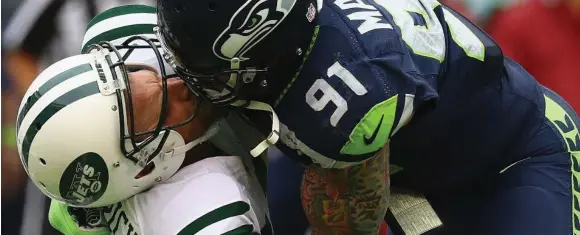  ?? AL BELLO/GETTY IMAGES FILE PHOTO ?? Helmet-jarring hits, much like this one by Seahawk Cassius Marsh on then-Jets QB Ryan Fitzpatric­k, raise questions about the future of football with links to brain damage irrefutabl­e.